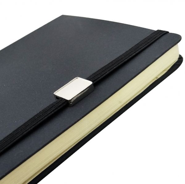 notebook with elastic band and plaque